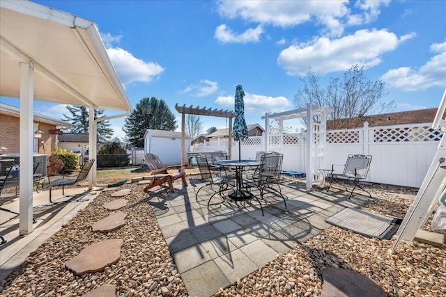 view of patio with a shed and a pergola