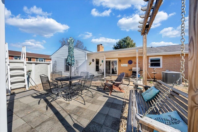 back of property with a patio and cooling unit