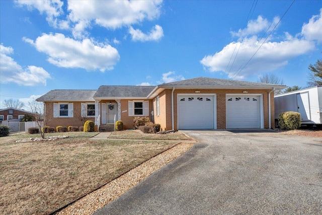 single story home with a garage and a front lawn