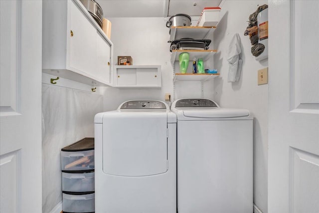 laundry area with cabinets and separate washer and dryer