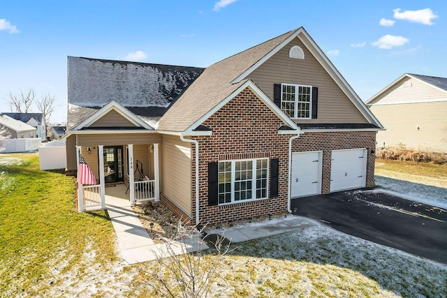 view of front of home featuring a garage, covered porch, and a front lawn