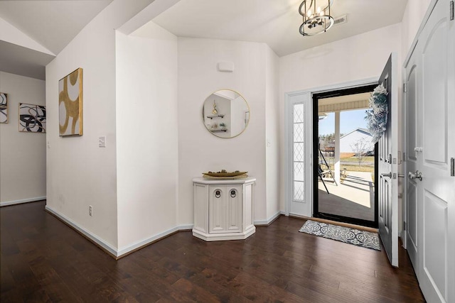 foyer entrance with lofted ceiling and dark hardwood / wood-style flooring