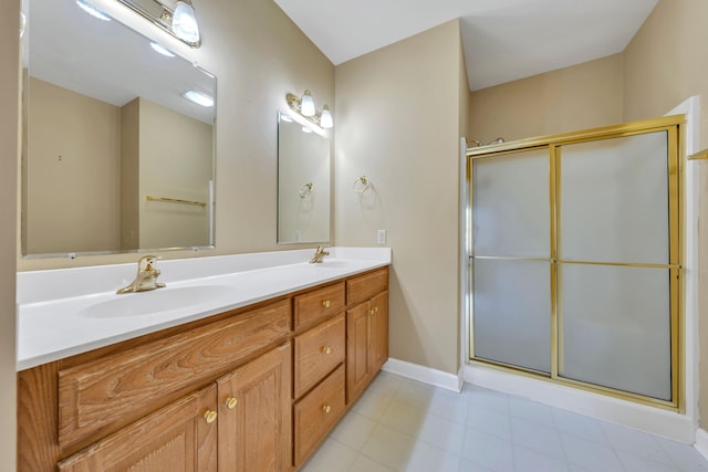 3040 Mcvitty Forest Dr Unit 211, Roanoke, VA 24018 - bathroom featuring double vanity, a sink, baseboards, and an enclosed shower