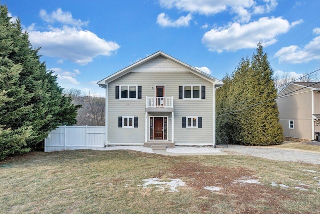 front of property featuring a balcony and a front yard