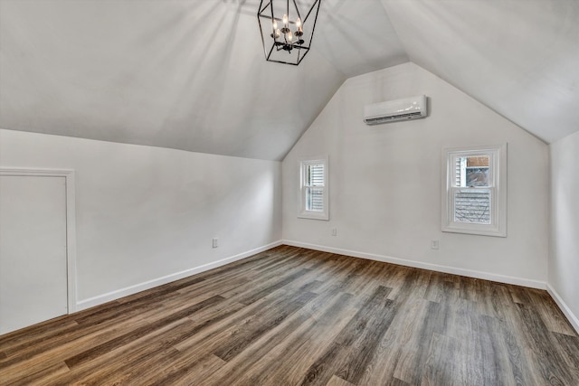 bonus room featuring lofted ceiling, dark hardwood / wood-style flooring, and a wall mounted AC