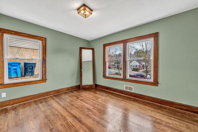 spare room with hardwood / wood-style floors