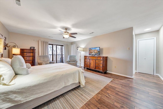 bedroom with hardwood / wood-style floors and ceiling fan