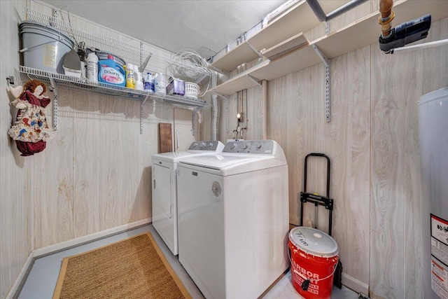 laundry room featuring water heater and washing machine and clothes dryer