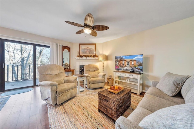 living room with ceiling fan and wood-type flooring