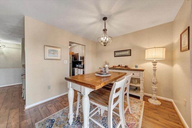 dining room featuring an inviting chandelier and hardwood / wood-style floors