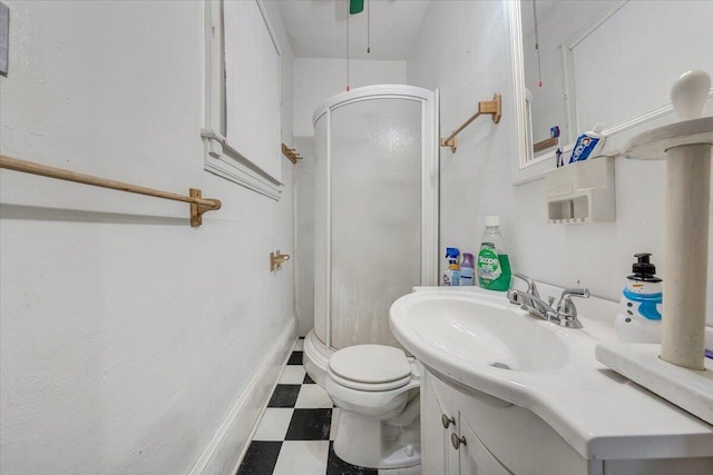 bathroom featuring vanity, toilet, and walk in shower