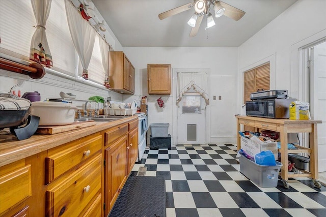 kitchen featuring ceiling fan and sink