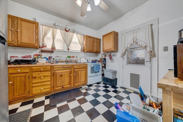 kitchen featuring white electric stove, sink, ceiling fan, and decorative backsplash