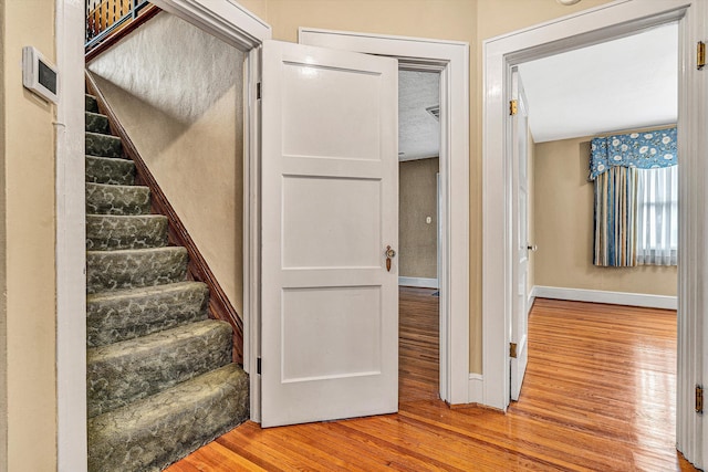 staircase featuring hardwood / wood-style flooring