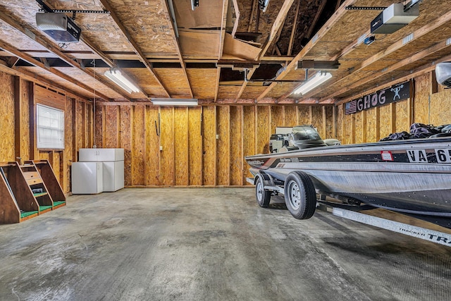 garage with a garage door opener and refrigerator