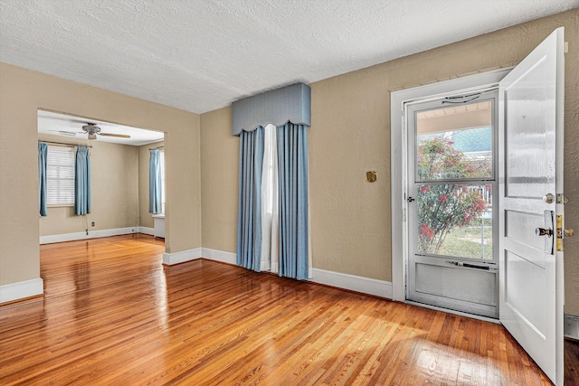 interior space with hardwood / wood-style flooring and a textured ceiling