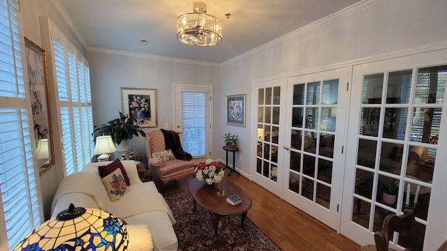 interior space with crown molding, hardwood / wood-style floors, and a notable chandelier