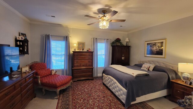 carpeted bedroom featuring ornamental molding and ceiling fan