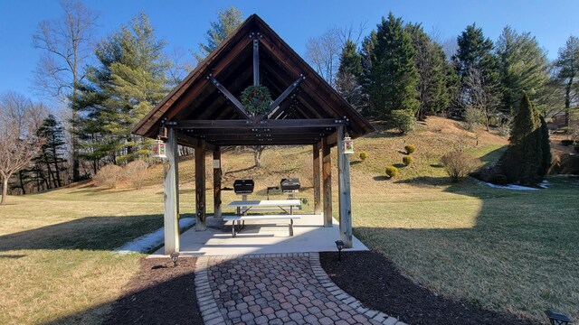 view of property's community with a yard and a patio area