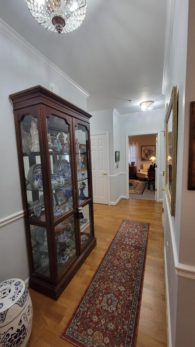 hall with crown molding and hardwood / wood-style flooring