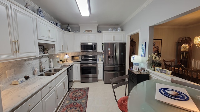 kitchen featuring white cabinetry, appliances with stainless steel finishes, sink, and backsplash