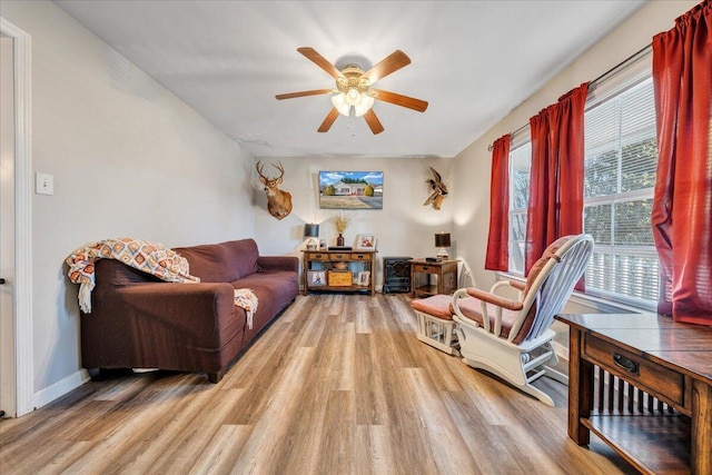 sitting room with light hardwood / wood-style flooring, a wealth of natural light, and ceiling fan