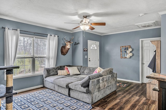 living room with visible vents, crown molding, and wood finished floors