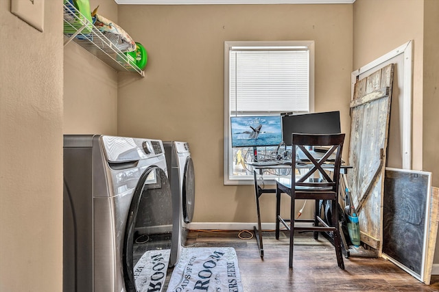 laundry room featuring washer and dryer, baseboards, wood finished floors, and laundry area