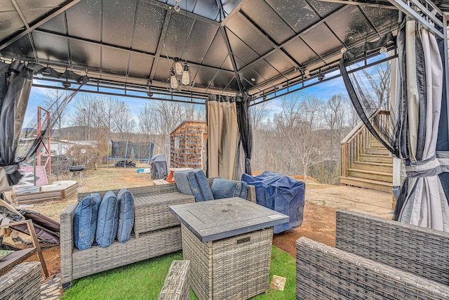 view of patio / terrace featuring a gazebo, stairs, and a trampoline