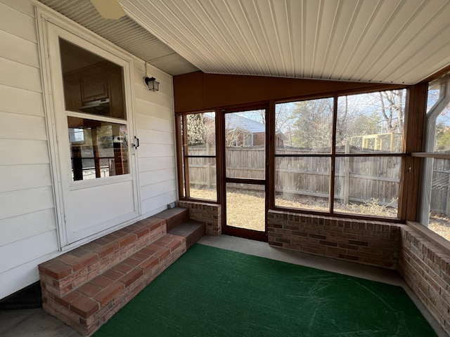 sunroom / solarium featuring vaulted ceiling and wooden ceiling