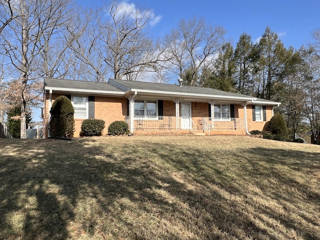 single story home featuring a porch and a front lawn