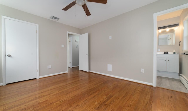 unfurnished bedroom featuring connected bathroom, light hardwood / wood-style flooring, and ceiling fan