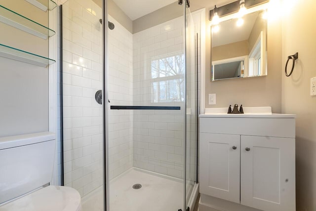 bathroom featuring walk in shower, vanity, and toilet