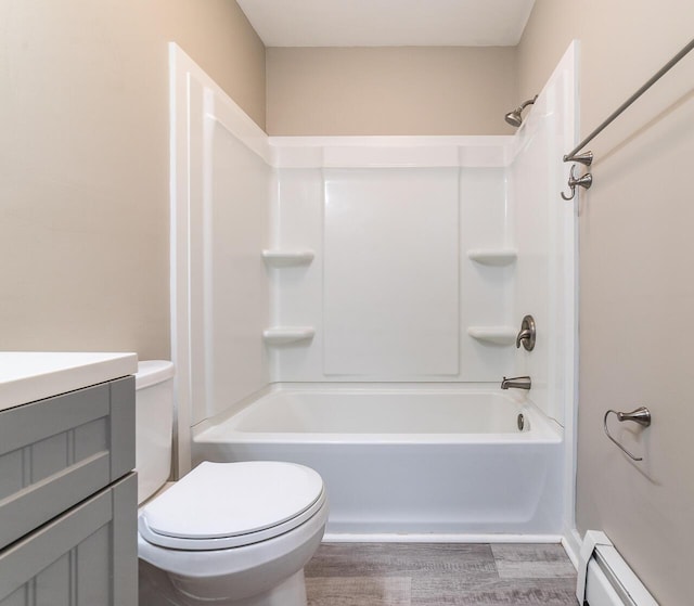 full bathroom featuring a baseboard radiator,  shower combination, vanity, and toilet