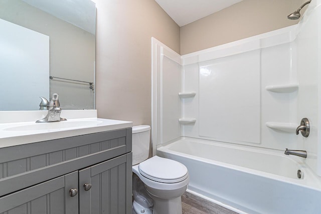 full bathroom featuring toilet, vanity, bathtub / shower combination, and hardwood / wood-style floors