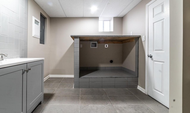 bathroom with vanity, a paneled ceiling, and tile patterned floors