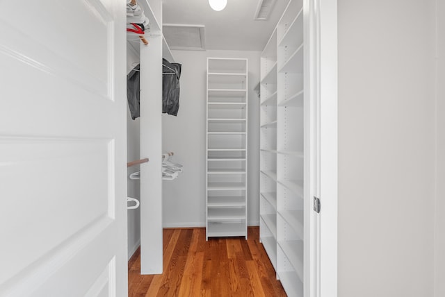 spacious closet with hardwood / wood-style flooring