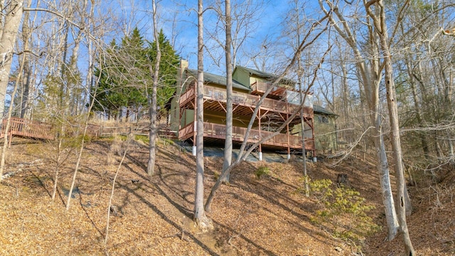 back of property featuring a wooden deck