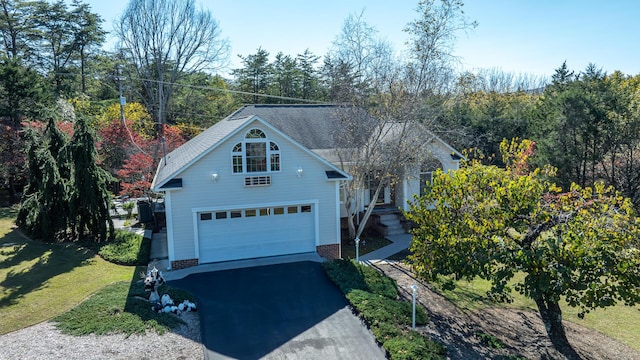 view of front of house featuring a garage and a front yard