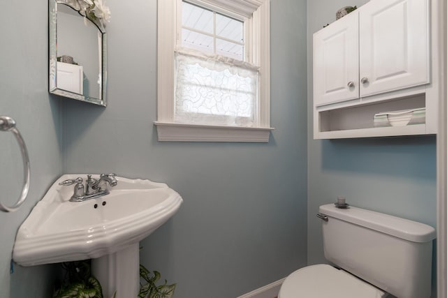 half bathroom with toilet and a sink