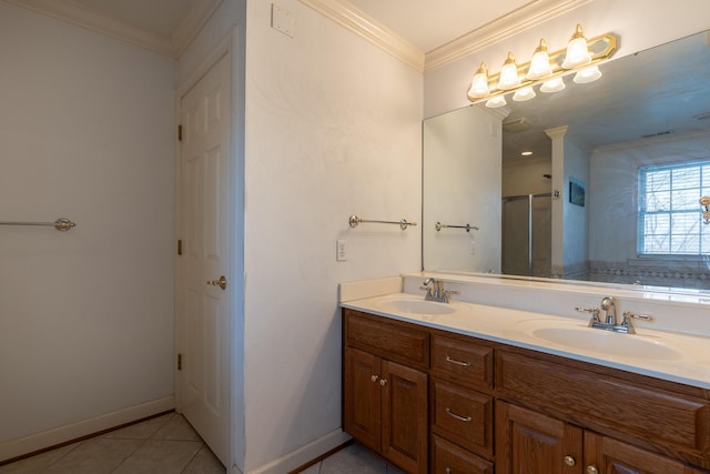 bathroom featuring tile patterned flooring, crown molding, double vanity, and a sink