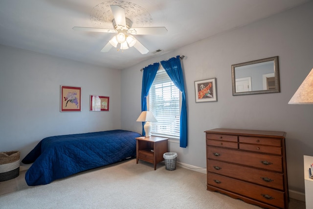 carpeted bedroom featuring visible vents and ceiling fan