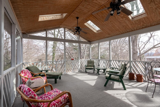 sunroom featuring wood ceiling, a ceiling fan, and a wealth of natural light