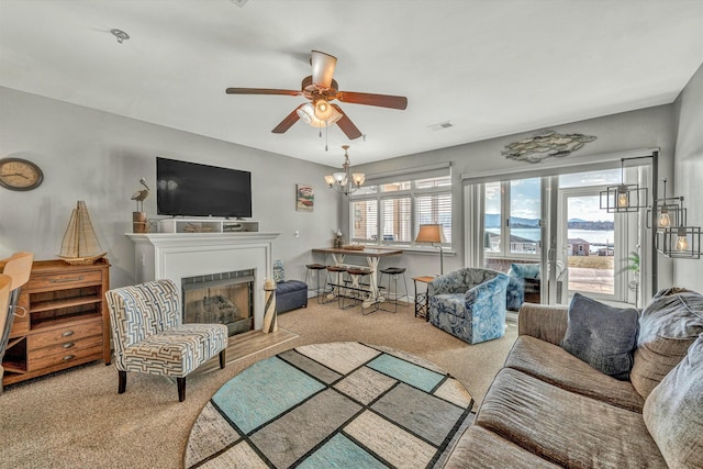 living room with ceiling fan with notable chandelier and light carpet