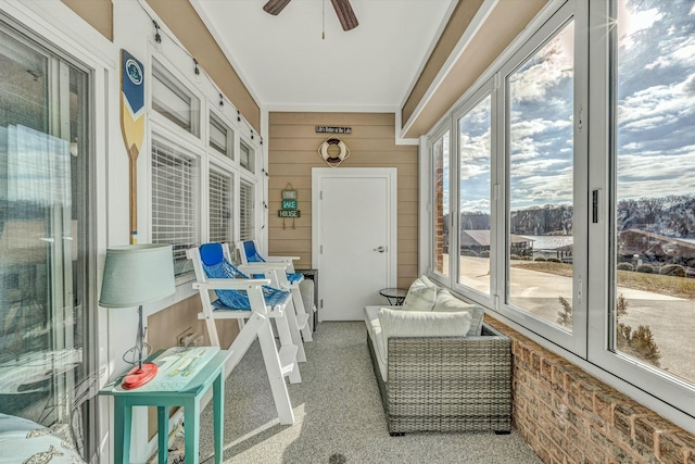 sunroom featuring ceiling fan