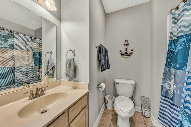 bathroom featuring tile patterned flooring, vanity, toilet, and walk in shower