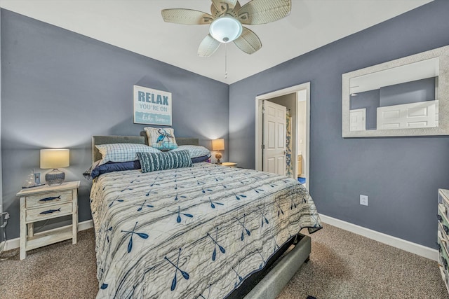 bedroom with ceiling fan, dark carpet, and ensuite bath