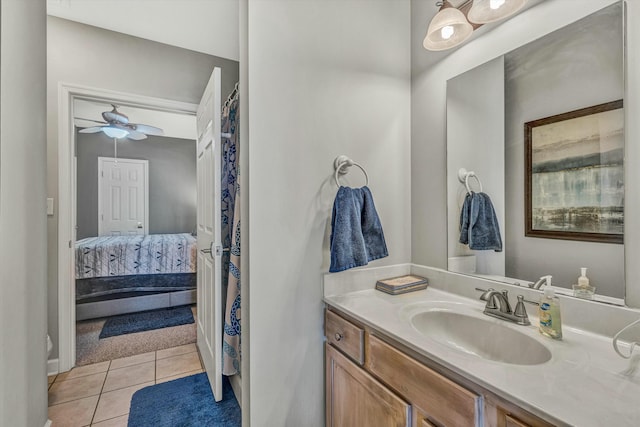 bathroom with tile patterned flooring, vanity, and ceiling fan