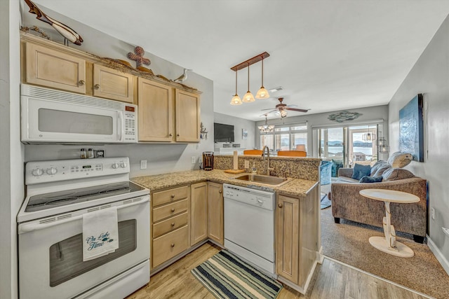 kitchen with sink, light brown cabinets, white appliances, and kitchen peninsula