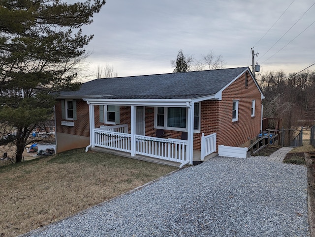 view of front of property featuring a porch and a lawn